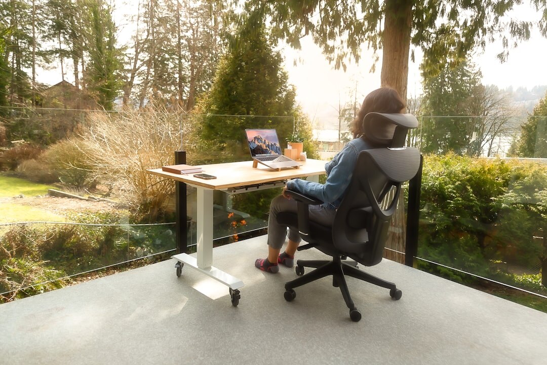 Woman working on a laptop at a desk in an office